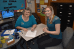 Disability Services employees Alisa Kotaska and Susan Sacco sit at a table