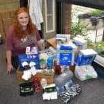 female student with donations for nursing home