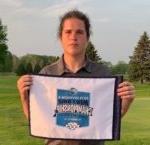 golfer Rielly McGranahan holding small tournament banner