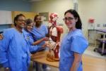 BHC Practical Nursing students in scrubs with a human anatomy model