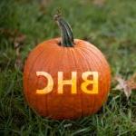 pumpkin on grass with letters BHC on it