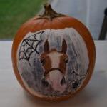 real pumpkin with a horse, spider webs and a spider painted on it